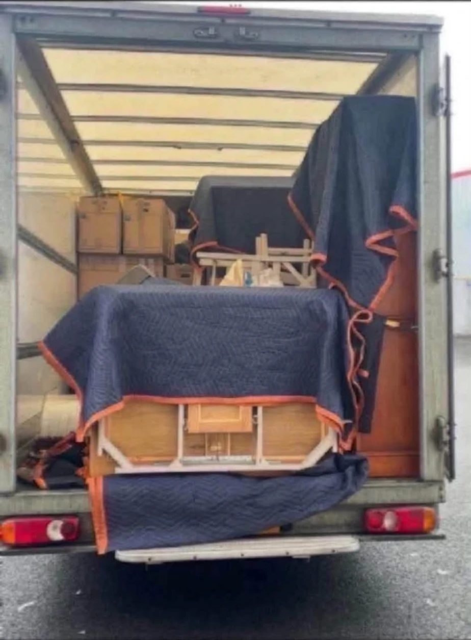 Furniture carefully wrapped and loaded inside the van